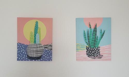 two paintings of a cactus on a wall at Blend Coliving One - 1 in Ribeirão Preto