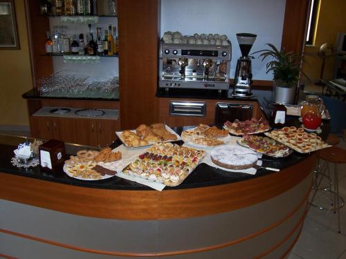 a buffet with many different types of food on a counter at Hotel Brindor in Poirino