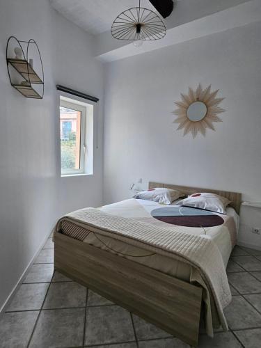 une chambre avec un lit et un miroir au mur dans l'établissement Appartement dans ancien moulin à huile rénové, à Grasse