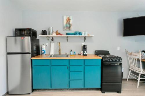 a kitchen with a refrigerator and a sink and a stove at Breakwater Resort in Grayland