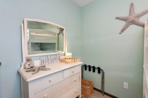 a room with a dresser with a mirror on it at Breakwater Resort in Grayland