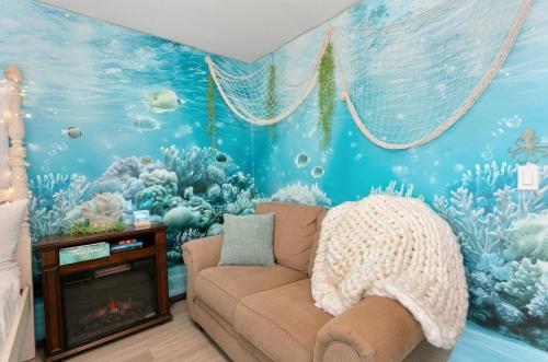 a living room with an under the ocean mural at Breakwater Resort in Grayland
