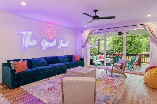 a living room with a blue couch and the good room sign at Home Near Lenovo Center and Carter Finley in Raleigh
