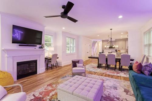a living room with a fireplace and a dining room at Home Near Lenovo Center and Carter Finley in Raleigh