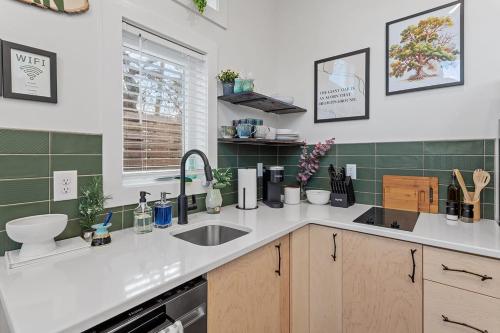 a kitchen counter with a sink and a window at Home and Guest Home in Historic Oakwood in Raleigh