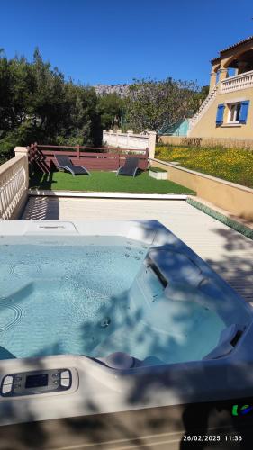 a hot tub in the backyard of a house at La Maison Bleue in Toulon