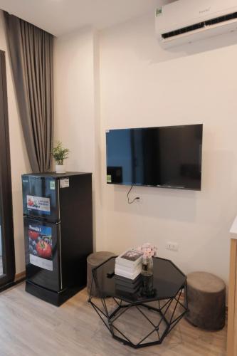 a living room with a table and a flat screen tv at Sam Sam Studio - 2 Dragons WestLake - Washing machine in Hanoi
