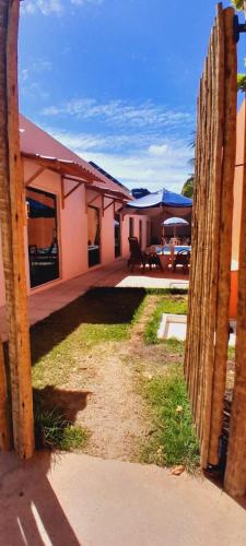 a view of a house through a fence at Pousada Flor da Barra in Maragogi