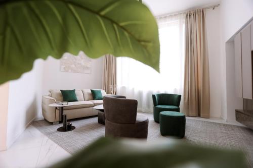 a living room with a couch and green chairs at Duomo Florence - Esclusive Luxury in Florence