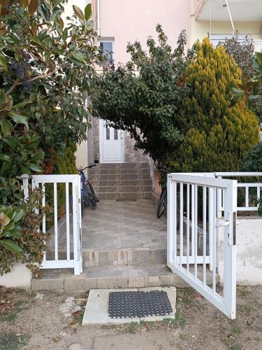 a pair of white gates in front of a house at joanna's house in Alexandroupoli
