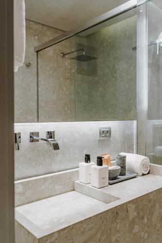 a bathroom with a counter with a sink and a mirror at Pousada Maria do Mar in Fernando de Noronha