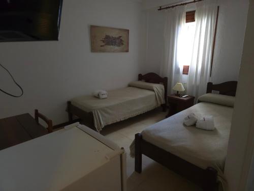 a room with two beds and a window at Hotel Dubrava in Ostende