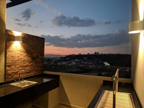 a bathroom with a sink and a window with a view at Ejecutivo y ubicado pool gym security in Hércules