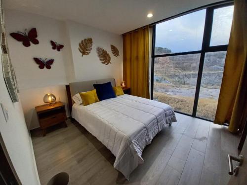 a bedroom with a bed with butterflies on the wall at Ejecutivo y ubicado pool gym security in Hércules