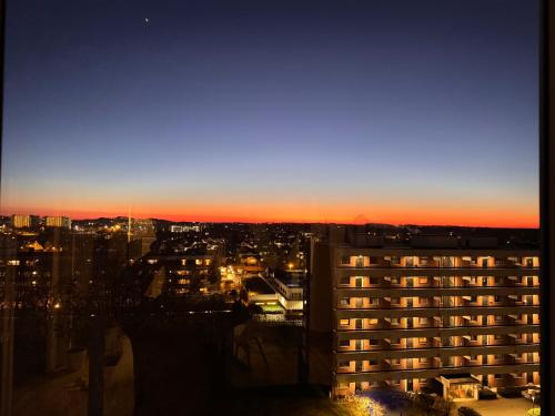 a view of a city at sunset from a building at Koselig leilighet in Stavanger