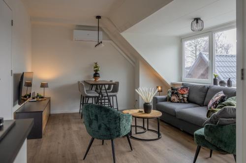 a living room with a couch and a table at Brugs home 2 in Barneveld