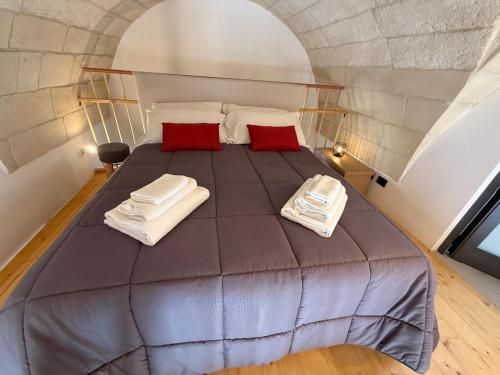 a bedroom with a bed with two towels on it at A Volte nel Salento-Porta Napoli in Lecce