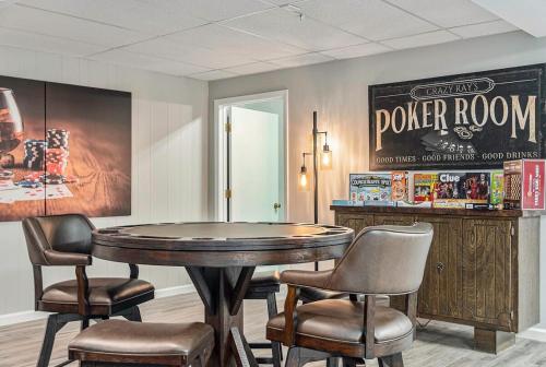 a table and chairs in a room with a sign on the wall at Majestic VIEWS FunAmenities & Best for Huge Group in Council Bluffs