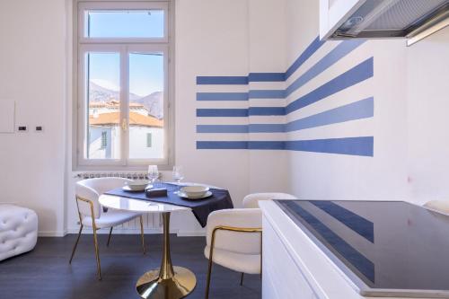 a dining room with a table and chairs at Le Acque Menaggio in Menaggio