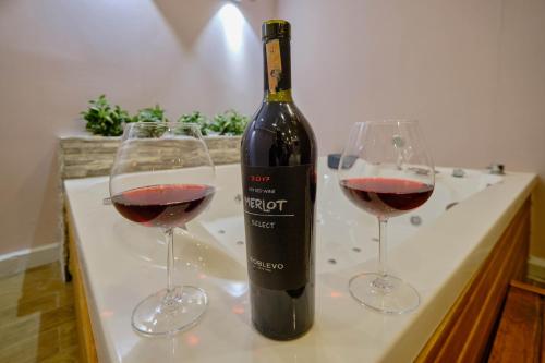 two glasses of red wine sitting on a table at Private Apartment at Beylikdüzü nearly to E5 2 in Beylikduzu