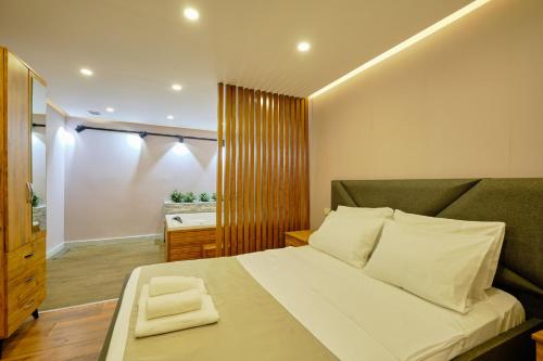 a bedroom with a large bed with a green couch at Private Apartment at Beylikdüzü nearly to E5 2 in Beylikduzu