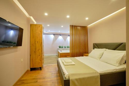 a small bedroom with a bed and a television at Private Apartment at Beylikdüzü nearly to E5 2 in Beylikduzu