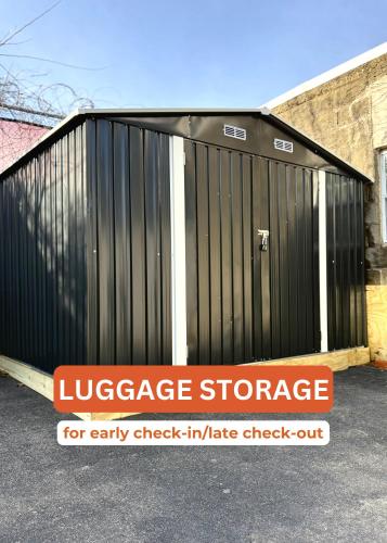 a large black garage with a sign in front of it at Parking 3BR2Bth Cambridge Boston W&D Subway AC in Somerville