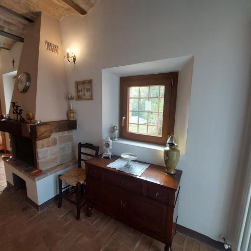 a room with a wooden dresser and a window at Borgo Pizzicarè in Vado