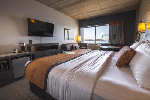 a hotel room with a large bed and a television at Pier B Resort in Duluth