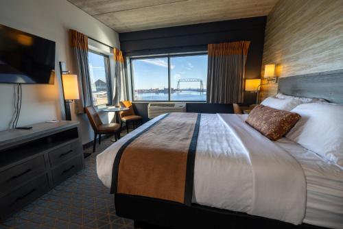 a hotel room with a large bed and a large window at Pier B Resort in Duluth