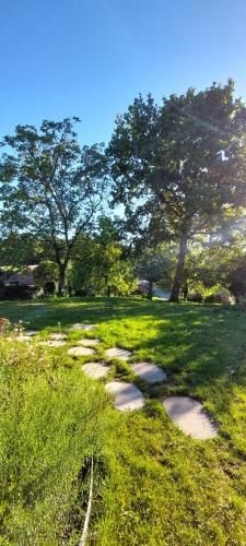 a path in a field with trees and grass at Boerderaaj vakantiewoning in Bilzen