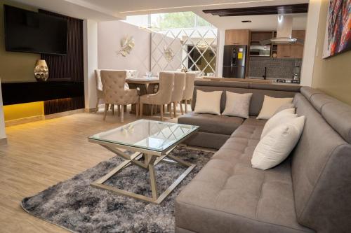 a living room with a couch and a table at Holiday Home with Pool in Baños Tungurahua in Baños