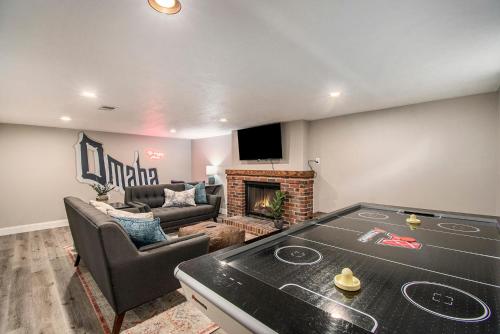 a living room with a ping pong table at Charming Benson Home Fenced Yard & BBQ in Omaha