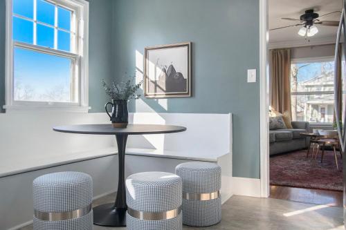 a living room with a table and stools at Charming Benson Home Fenced Yard & BBQ in Omaha