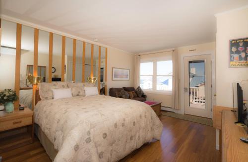 a bedroom with a large bed and a living room at The Montauk Soundview in Montauk