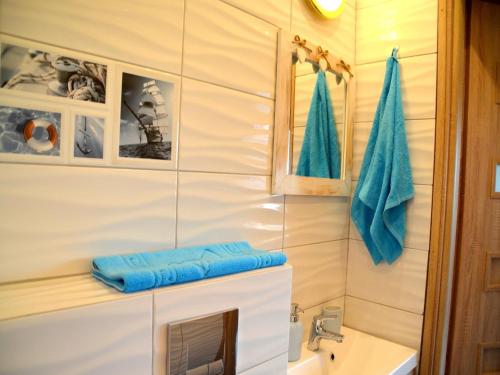 a bathroom with a sink and a mirror at House in Niechorze near Baltic Sea Beach in Niechorze