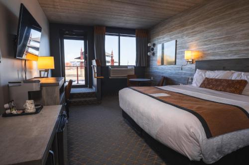 a hotel room with a large bed and a bathroom at Pier B Resort in Duluth