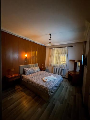 a bedroom with a bed and a television in it at Mk Big boss otel in Erzurum