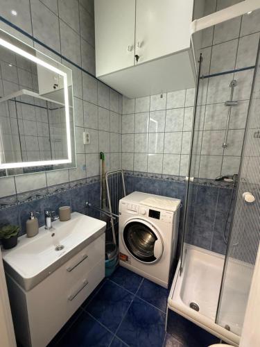 a bathroom with a washing machine and a washer at Buda Blue in Budapest