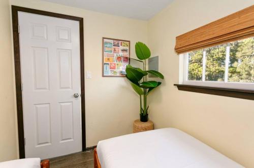 a bedroom with a white door and a potted plant at Breakwater Resort in Grayland