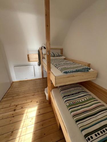 two bunk beds in a room with wooden floors at Family Friendly Mountain House in Eisenerz