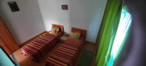 a room with two beds and a window at Casa loud in Sidi el Moujahed