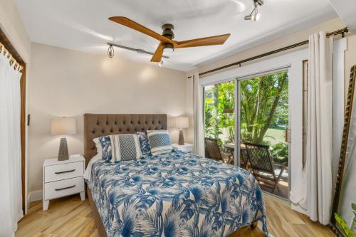 a bedroom with a bed and a large window at (P17D) Hale Blue Hawaii 1Br with Loft, Puamana, Pool, Wifi in Princeville
