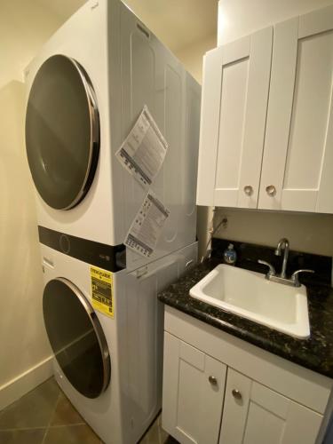 a small kitchen with a sink and a washing machine at (P17D) Hale Blue Hawaii 1Br with Loft, Puamana, Pool, Wifi in Princeville