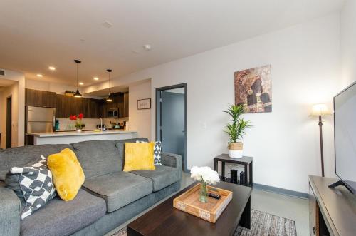 a living room with a couch and a table at Adorable 2bed Apt Balcony & Rooftop Pool D in Los Angeles