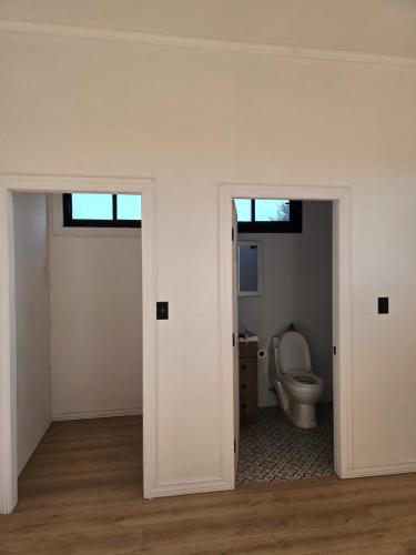 an empty bathroom with a toilet in a room at Parcela la Jacinta in Chillán