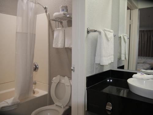 a bathroom with a white toilet and a sink at Motel 6-Tacoma, WA - South in Tacoma