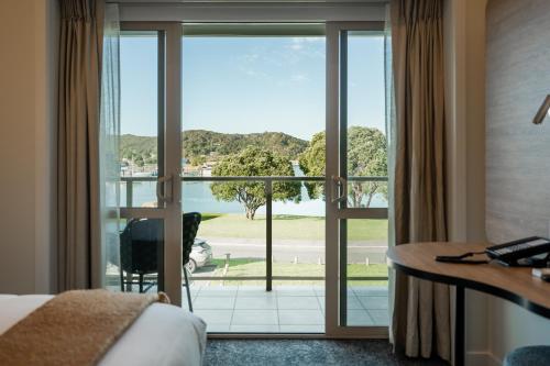 a hotel room with a view of the ocean at Copthorne Hotel & Resort Bay Of Islands in Paihia