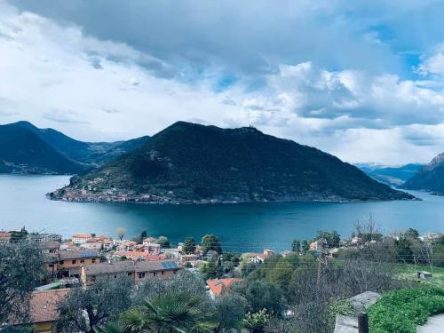 a view of a town on a lake with a mountain at Home La Torre next the station in Chiari