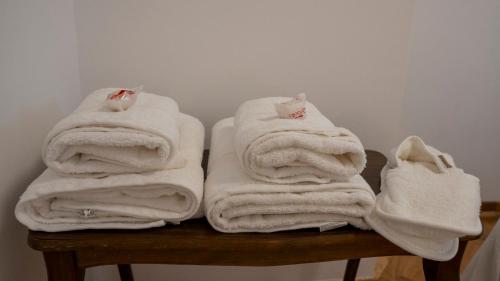 a pile of towels sitting on top of a table at Apartman Innocence Sajam in Novi Sad